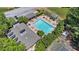 Aerial view of community pool with lounge chairs, tables, and adjacent tennis court surrounded by mature trees at 1201 Bridle Path, Marietta, GA 30068