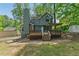 Inviting backyard featuring a spacious deck with pergola, lush lawn, and mature trees at 1502 Lake Koinonia Dr, Woodstock, GA 30189