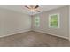 Neutral bedroom with plush carpeting, bright windows, and a ceiling fan for added comfort at 1502 Lake Koinonia Dr, Woodstock, GA 30189
