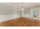 Traditional dining room boasting hardwood floors, elegant wainscoting, and a stylish chandelier at 1502 Lake Koinonia Dr, Woodstock, GA 30189