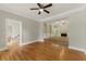 Open-concept living room with hardwood floors, a cozy fireplace, and abundant natural light at 1502 Lake Koinonia Dr, Woodstock, GA 30189