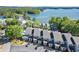 Stunning aerial view of lakeside condos with lush trees and community pool at 2300 Harbersham Marina Rd # 102, Cumming, GA 30041
