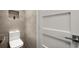 Modern bathroom featuring a toilet with a tile wall niche, and a white door with steel handle at 2300 Harbersham Marina Rd # 102, Cumming, GA 30041