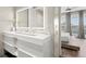 Modern bathroom featuring double vanity, LED mirror, and an open view to the main bedroom at 2300 Harbersham Marina Rd # 102, Cumming, GA 30041