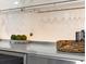 A countertop, basket, glassware, and a decorative plant on a modern countertop at 2300 Harbersham Marina Rd # 102, Cumming, GA 30041