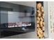 Sleek modern fireplace beside decorative stacked logs, adding warmth and a stylish touch to the living space at 2300 Harbersham Marina Rd # 102, Cumming, GA 30041