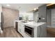 Modern kitchen island with stainless steel appliances, sink, and granite countertops, and views to the living room at 2300 Harbersham Marina Rd # 102, Cumming, GA 30041