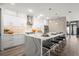Bright kitchen with white cabinetry, waterfall island, stainless appliances, and decorative backsplash at 2300 Harbersham Marina Rd # 102, Cumming, GA 30041