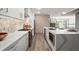 Spacious kitchen with stainless steel appliances, stone backsplash and granite countertops and a modern kitchen island at 2300 Harbersham Marina Rd # 102, Cumming, GA 30041