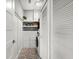 Well-organized laundry room with built-in shelving, washer/dryer, and attractive flooring at 2300 Harbersham Marina Rd # 102, Cumming, GA 30041
