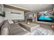 Spacious living room with hardwood floors, a large sectional sofa, and an extra-large flat screen TV at 2300 Harbersham Marina Rd # 102, Cumming, GA 30041