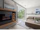 Cozy living room with hardwood floors, modern fireplace, and access to the outdoor balcony at 2300 Harbersham Marina Rd # 102, Cumming, GA 30041