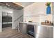Modern wet bar with an under-counter wine fridge, sink, and hanging stemware at 2300 Harbersham Marina Rd # 102, Cumming, GA 30041