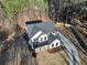 Aerial view of a newly constructed two-story home with a modern design and a long driveway at 3785 Pilgrim Mill Rd, Cumming, GA 30041