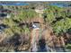 Aerial view of a home surrounded by trees with a long driveway and lake nearby at 3785 Pilgrim Mill Rd, Cumming, GA 30041