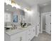 Bright bathroom featuring double sinks, marble floors, and a soaking tub at 3785 Pilgrim Mill Rd, Cumming, GA 30041