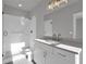 A bathroom with a glass shower door and vanity with ample lighting at 3785 Pilgrim Mill Rd, Cumming, GA 30041