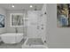 A modern bathroom showcasing a glass shower, tub, sleek fixtures, and natural light at 3785 Pilgrim Mill Rd, Cumming, GA 30041