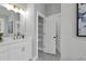 Bright bathroom with a modern vanity, an open closet, and neutral paint at 3785 Pilgrim Mill Rd, Cumming, GA 30041