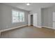Sunlit bedroom boasts hardwood floors and a view of the natural landscape, creating a serene atmosphere at 3785 Pilgrim Mill Rd, Cumming, GA 30041