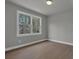 This bedroom has neutral colors and hardwood floors at 3785 Pilgrim Mill Rd, Cumming, GA 30041