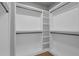 A bright walk-in closet with built-in shelving and clothing rods at 3785 Pilgrim Mill Rd, Cumming, GA 30041