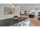 Open-concept dining area with view into the kitchen and living room, featuring modern decor and lighting at 3785 Pilgrim Mill Rd, Cumming, GA 30041