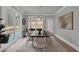 Elegant dining room featuring stylish furniture, a modern light fixture, and a backyard view at 3785 Pilgrim Mill Rd, Cumming, GA 30041