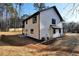 View of the rear exterior of a charming two-story home with white siding and a spacious backyard at 3785 Pilgrim Mill Rd, Cumming, GA 30041