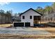 Expansive driveway leads to this modern home with a stylish two-car garage and inviting exterior design at 3785 Pilgrim Mill Rd, Cumming, GA 30041