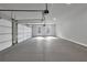 Spacious garage with a concrete floor, two windows, and an automatic door at 3785 Pilgrim Mill Rd, Cumming, GA 30041