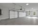 Spacious three-car garage with ample room for vehicles and storage at 3785 Pilgrim Mill Rd, Cumming, GA 30041