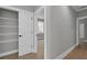 Open hallway with luxury vinyl plank flooring and closet space at 3785 Pilgrim Mill Rd, Cumming, GA 30041