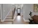 Hallway with hardwood floors, staircase, front door, and modern light fixture at 3785 Pilgrim Mill Rd, Cumming, GA 30041