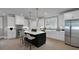 Bright kitchen with stainless steel appliances, island with breakfast bar, and white cabinetry at 3785 Pilgrim Mill Rd, Cumming, GA 30041
