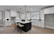 Modern kitchen featuring an island with seating, white cabinets, hardwood floors, and stainless steel appliances, a great place to cook at 3785 Pilgrim Mill Rd, Cumming, GA 30041