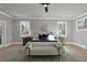 Well-lit primary bedroom with hardwood floors and large windows overlooking nature at 3785 Pilgrim Mill Rd, Cumming, GA 30041