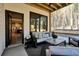 Covered outdoor patio with comfortable seating and view into the backyard at 3785 Pilgrim Mill Rd, Cumming, GA 30041