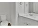 Bright half-bath with toilet and a modern vanity featuring a white countertop and cabinet at 4965 Whiteoak Se Walk # 19, Smyrna, GA 30080