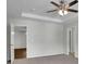 Cozy bedroom with a ceiling fan, neutral carpet, and multiple doorways at 4965 Whiteoak Se Walk # 19, Smyrna, GA 30080
