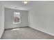 Neutral bedroom showcasing plush carpeting and natural light through a window at 4965 Whiteoak Se Walk # 19, Smyrna, GA 30080
