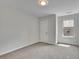 Neutral bedroom featuring carpeted floors, a window for natural light, and a classic door at 4965 Whiteoak Se Walk # 19, Smyrna, GA 30080