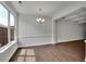 Bright dining room area featuring hardwood floors, modern chandelier, and natural light from large windows at 4965 Whiteoak Se Walk # 19, Smyrna, GA 30080