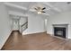 Inviting living room with hardwood floors, fireplace, coffered ceiling, and stairs leading to upper level at 4965 Whiteoak Se Walk # 19, Smyrna, GA 30080