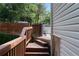Stairs leading to the backyard, surrounded by lush greenery and a wooden fence, and an access gate at 5029 David Pl, Smyrna, GA 30082