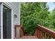 Exterior view of deck access to backyard, surrounded by mature trees offering privacy at 5029 David Pl, Smyrna, GA 30082