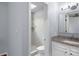 Clean bathroom with tiled shower, granite vanity, and toilet at 5029 David Pl, Smyrna, GA 30082