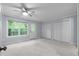 Spacious bedroom with neutral carpet, closet, and a door to the outside overlooking private backyard at 5029 David Pl, Smyrna, GA 30082