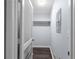 Hallway features wood floors, shelving, and a white louvered door at 5029 David Pl, Smyrna, GA 30082