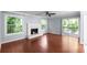 Bright living room featuring hardwood floors, a fireplace, and sliding glass doors to a deck at 5029 David Pl, Smyrna, GA 30082